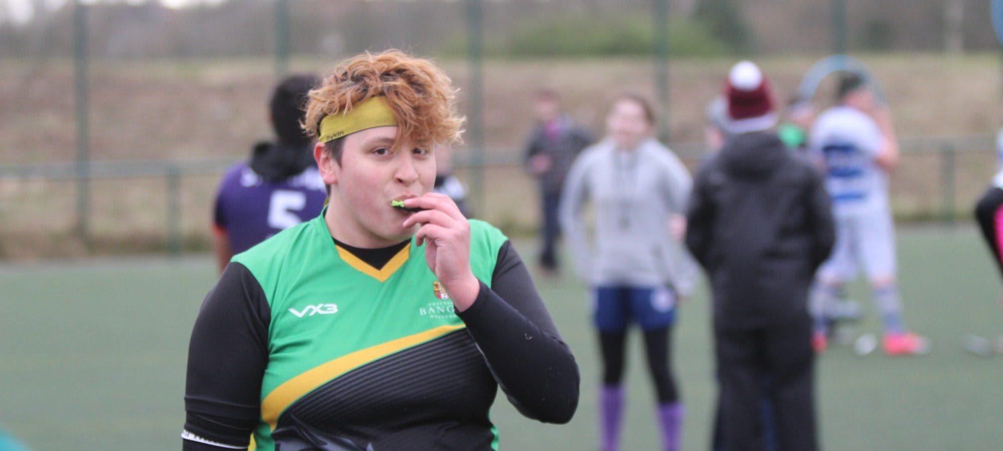 Chloe Durkin smiles at the camera with a mouthguard in