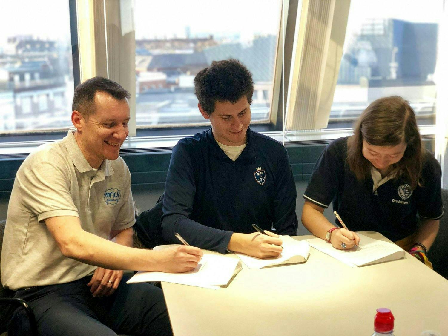 Representatives from QPL, QuidditchUK and Enrich education sign papers